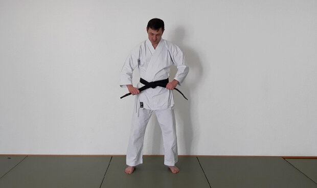 Beide Enden des Karate Gürtels festziehen